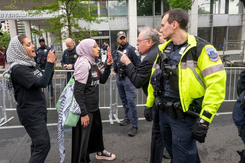 White House Correspondents' Association Dinner attendee, second right, confronts a protester before the start of the event outside the Washington Hilton on Saturday, April 27, 2024, in Washington. (AP Photo/Kevin Wolf)