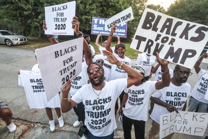 August 24, 2023 Atlanta:  Maurice Symonette (center) leads Blacks for Trump protesters late Thursday morning, Aug. 24, 2023 where there were more than 100 protestors gathered outside the jail, and they were prepared to wait for hours until the anticipated arrival of former President Donald Trump this afternoon.  (John Spink / John.Spink@ajc.com)


