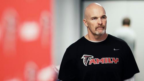 Atlanta Falcons head coach Dan Quinn walks into a press conference Wednesday in Flowery Branch.