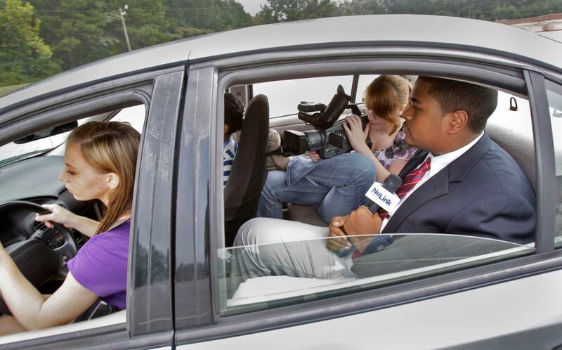 August 1, 2012 - Newnan - Amber Rogers (left) takes the wheel as Leah Gaillot and Caleb Britt film their segment on texting and driving. Students at Central Education Center, a public charter school in Cowetta County, help produce "The Link", a local cable television program. CEC has received national acclaim for its efforts in preparing students for work after high school. The students also produced their own segment on for the show on the dangers of texting and driving. BOB ANDRES / BANDRES@AJC.COM