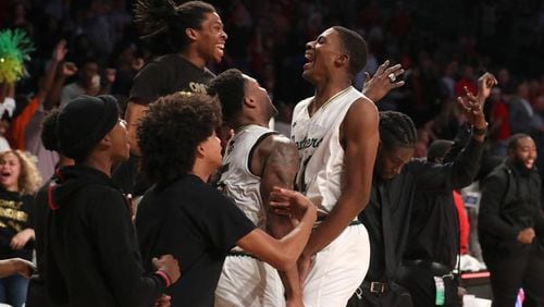 March 9, 2018 - Atlanta, Ga: Hughes guard Landers Nolley (21, center) celebrates with teammates after they defeated Gainesville during the GHSA Class AAAAAA Boys State Championship at McCamish Pavilion Friday, March 9, 2018, in Atlanta. Hughes won 85-78.