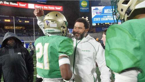Buford coach Bryant Appling celebrates with Jalen Huff after beating Warner Robins