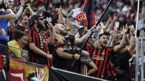 Atlanta United fans celebrate the team's first goal to tie the game 1-1 during the second half at Mercedes-Benz Stadium on July 17. (Miguel Martinez / Miguel.martinezjimenez@ajc.com)