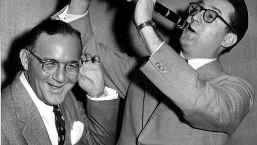 April 20, 1955 - New York: Benny Goodman, the ‘King of Swing’ himself, can hardly believe his ears as comedian Steve Allen makes with a few hot licks on the ‘licorice stick.’ Goodman, who is usually on the business end of the clarinet, is soon to be honored by a Hollywood film biography. Allen has been selected to play goodman in the forthcoming ‘Benny Goodman Story’ and the jazz great seem to like the idea. (Credit: United Press Photo) 4-20-55