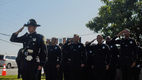 Officers honor their fallen comrade at the highway naming ceremony.