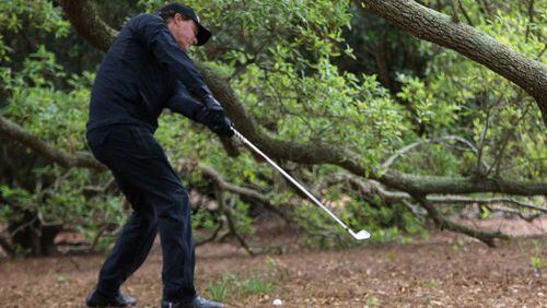 Phil Mickelson whiffs his first shot out of the woods on the first hole where he took a seven during the third round of the Masters at Augusta National Golf Club on Saturday, April 7, 2018, in Augusta.  Curtis Compton/ccompton@ajc.com