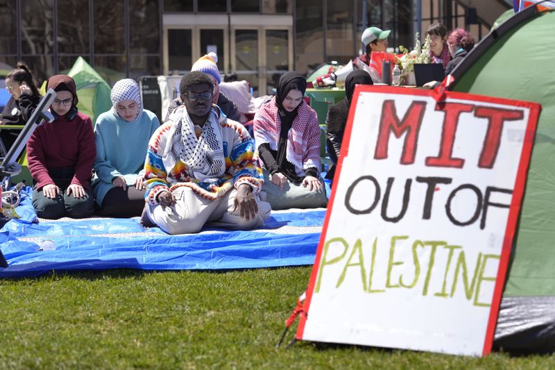 Massachusetts Institute of Technology student Isa Liggans, of Odenton, Md., front left, takes part in Muslim prayer with others Monday, April 22, 2024, at an encampment of tents at MIT, in Cambridge, Mass. Students at MIT set up the encampment of tents on campus to protest what they said was MIT's failure to call for an immediate ceasefire in Gaza and to cut ties to Israel's military. (AP Photo/Steven Senne)