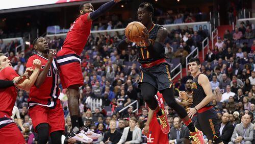 WASHINGTON, DC - MARCH 22: Dennis Schroder #17 of the Atlanta Hawks looks to pass around John Wall #2 of the Washington Wizards at Verizon Center on March 22, 2017 in Washington, DC.  NOTE TO USER: User expressly acknowledges and agrees that, by downloading and or using this photograph, User is consenting to the terms and conditions of the Getty Images License Agreement.  (Photo by Rob Carr/Getty Images)