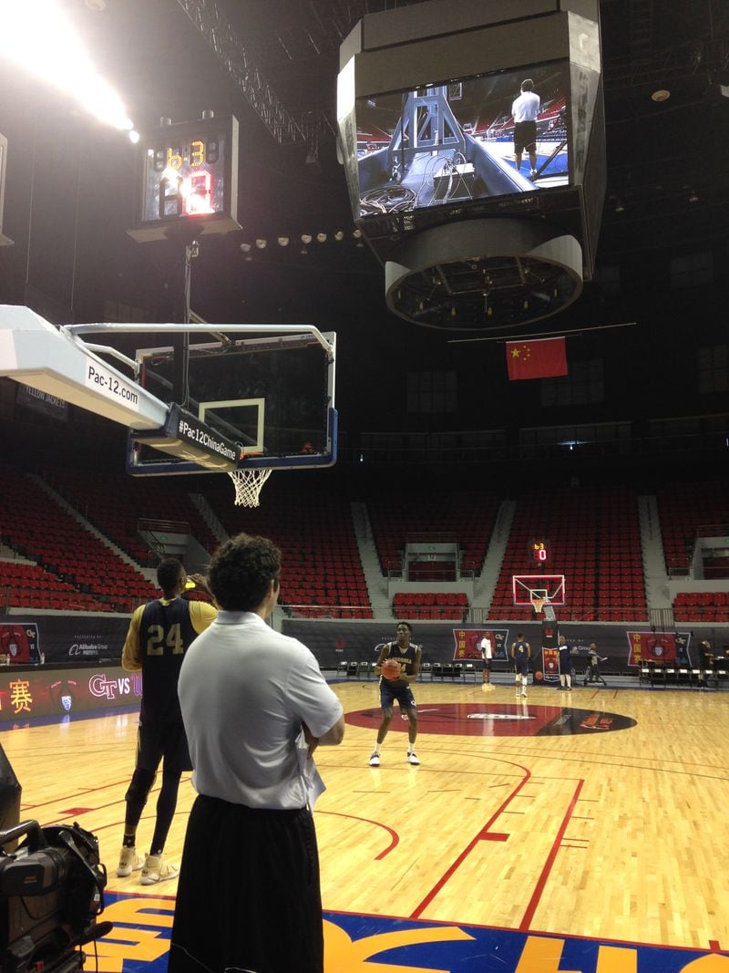 Josh Pastner watches Abdoulaye Gueye shoot free throws after a practice at Baoshan Arena. Brandon Alston is at the other end of the court doing the same.