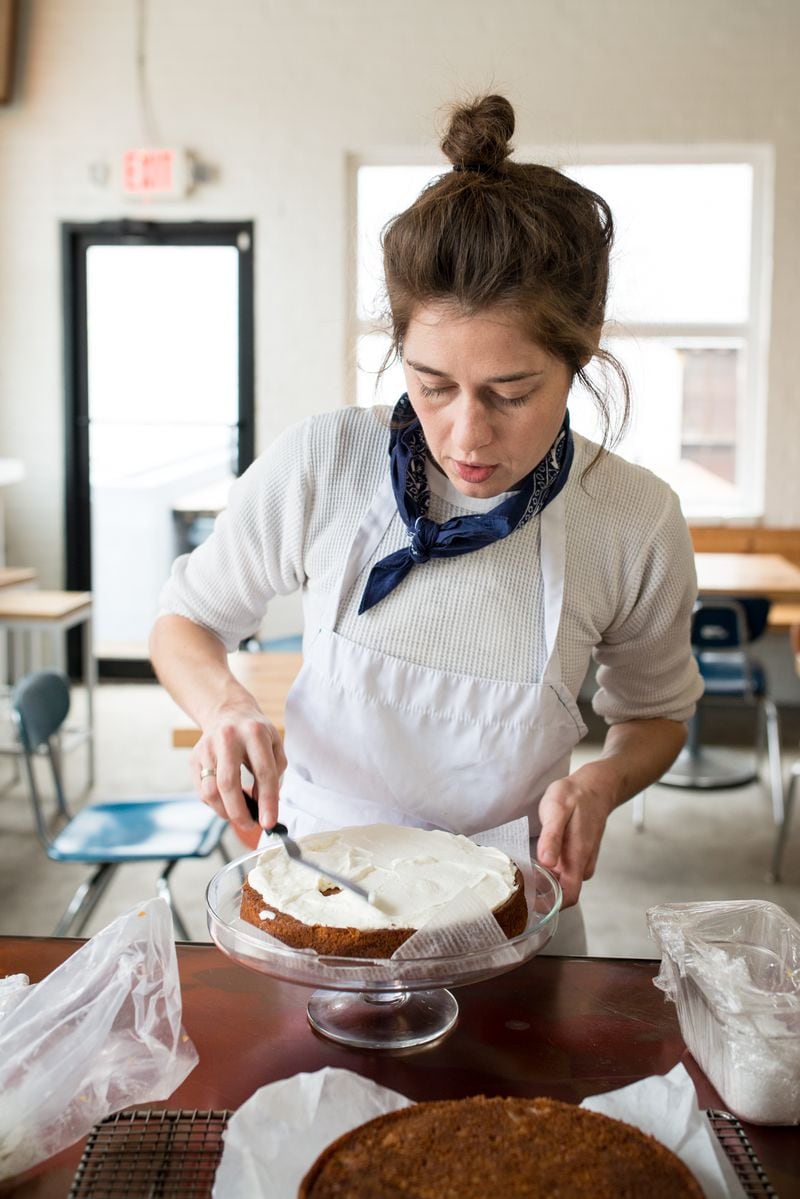  Sarah Dodge layers whipped creme fraiche on buttermilk cake. / Photo credit- Mia Yakel.