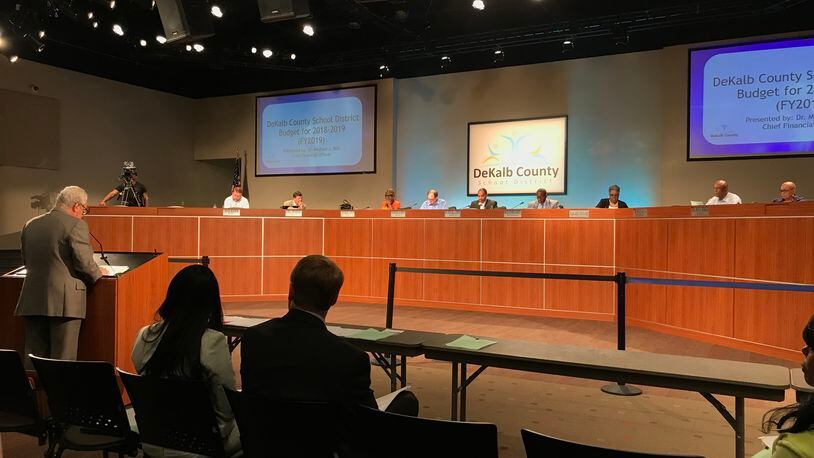 Chief Financial Officer Michael Bell, left at lectern, presents the 2019 budget to the DeKalb County Board of Education. (Marlon A. Walker/MARLON.WALKER@AJC.COM)