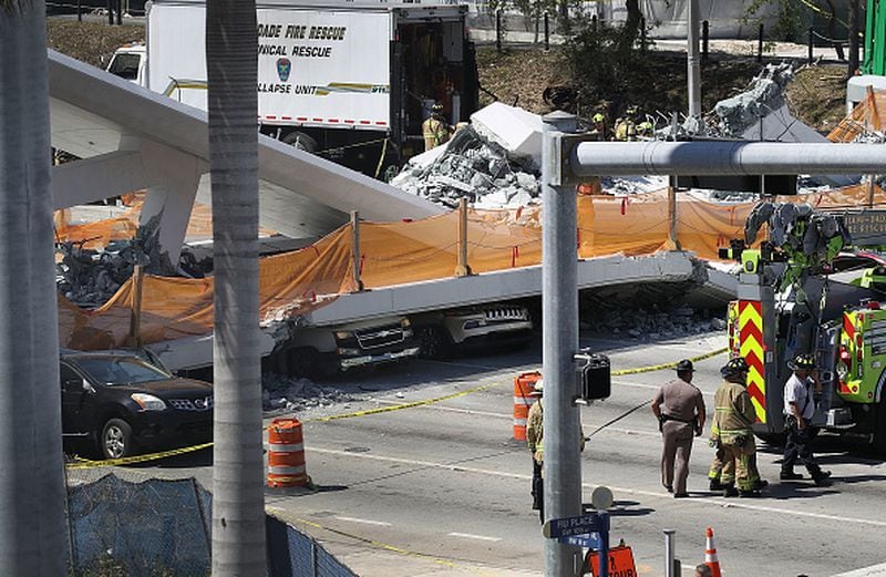 MIAMI, FL - MARCH 15:  Vehicles are seen trapped under the collapsed pedestrian bridge that was newly built over southwest 8th street allowing people to bypass the busy street to reach Florida International University on March 15, 2018 in Miami, Florida. Reports indicate that there are an unknown number of fatalities as a result of the collapse, which crushed at least five cars.  (Photo by Joe Raedle/Getty Images)