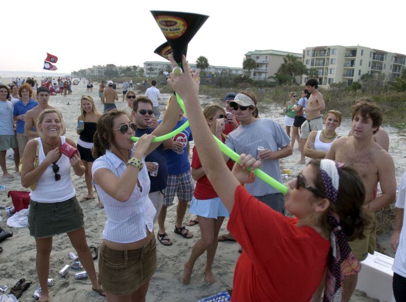University of Georgia fans gather at St. Simons Island's East Beach on the eve of the 2004 football game against the University of Florida in Jacksonville. More than a decade later, the tradition is going strong, but officials are trying to clamp down on the rowdy atmosphere, including apparent underage drinking. SPECIAL TO AJC