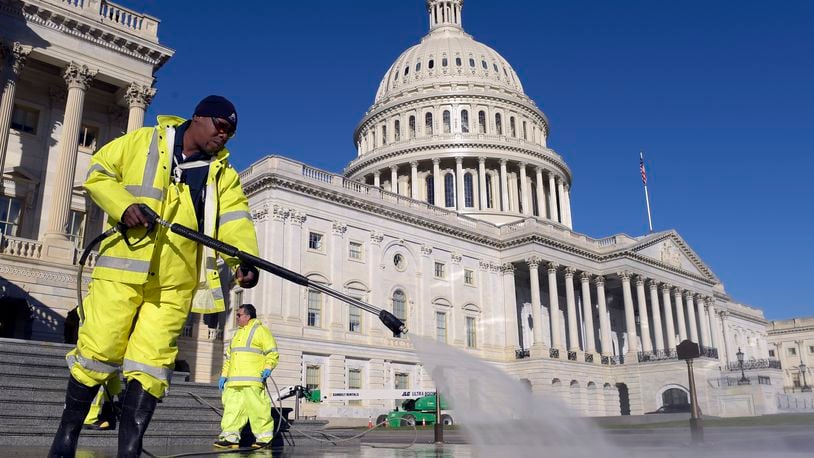 Carroll Rodgers of Suitland, Md., cleans the steps on Capitol Hill in Washington on Election Day. (AP Photo/Susan Walsh)