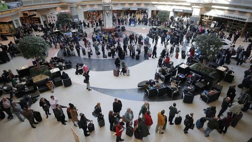 Security lines wrapped through the atrium and around the baggage areas and wait times were more than two hours long at Hartsfield-Jackson International Airport on Wednesday afternoon in the wake of a snowstorm due to a shortage of TSA screeners.BOB ANDRES /BANDRES@AJC.COM