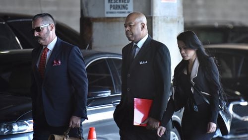 January 7, 2020 Atlanta -A former top Atlanta contracting official Larry Scott (center) walks into the Richard B. Russell Federal Courthouse for his sentencing on Tuesday, January 7, 2020. A former top Atlanta contracting official who admitted to being paid on the sly more than $220,000 over five years to help companies win government contracts -including with the city — is scheduled to be sentenced Tuesday morning in federal court. Larry Scott, who managed contract compliance for the city, pleaded guilty in September to wire fraud and filing false tax returns. He’s the third high-ranking city official to plead guilty in the wide-ranging federal corruption probe of City Hall, which dates to at least mid-2015. (Hyosub Shin / Hyosub.Shin@ajc.com)