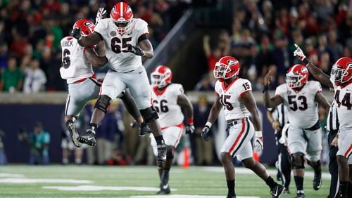 Kendall Baker (65) and Natrez Patrick (6) of the Georgia Bulldogs leap for joy after a big play in the fourth quarter. Photo by Joe Robbins/Getty Images)