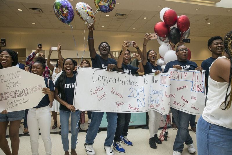 7/12/2019 — Atlanta, Georgia — Supporters cheer as members of the Harvard Diversity Project arrive to the domestic terminal at Hartsfield Jackson International Airport in Atlanta, Friday, July 12, 2019. The group, an Atlanta-based pipeline of the Harvard Debate Council, returned to Atlanta as champions of Harvard University’s annual international debate tournament. Two of the students, Don Jr. Roman and Keith Harris achieved an unprecedented, undefeated record. (Alyssa Pointer/alyssa.pointer@ajc.com)