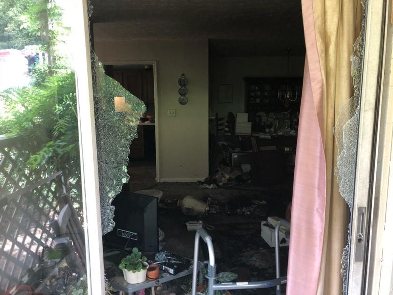 A Cobb County woman was pulled from her flaming condo by a neighbor Friday, July 20, 2018.