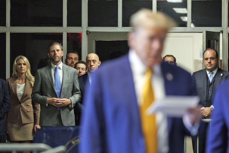 From left, Natalie Harp, Eric Trump, attorney Emil Bove, and Boris Epshteyn, right, listen as former President Donald Trump speaks to members of the media as he arrives at Manhattan criminal court, Tuesday, May 7, 2024, in New York. (Sarah Yenesel/Pool Photo via AP)