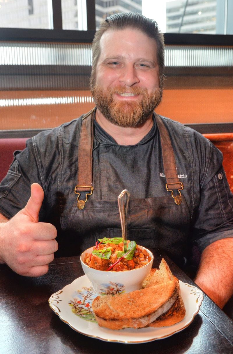 Executive Chef Michael Patria gives the thumbs-up to the final test of a real Kentucky Burgoo, when you can stand a spoon up in it. Styling by chef Michael Patria and Michelle Labovitz. CHRIS HUNT/SPECIAL