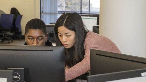 Georgia State University graduate student Ruixie Fang (right) answers a question from an undergraduate student taking a math final exam at the Mathematics Interactive Learning Environment Lab (MILE lab) at Georgia Sate University’s main campus in Altanta on Thursday, Dec. 6, 2018. ALYSSA POINTER / ALYSSA.POINTER@AJC.COM