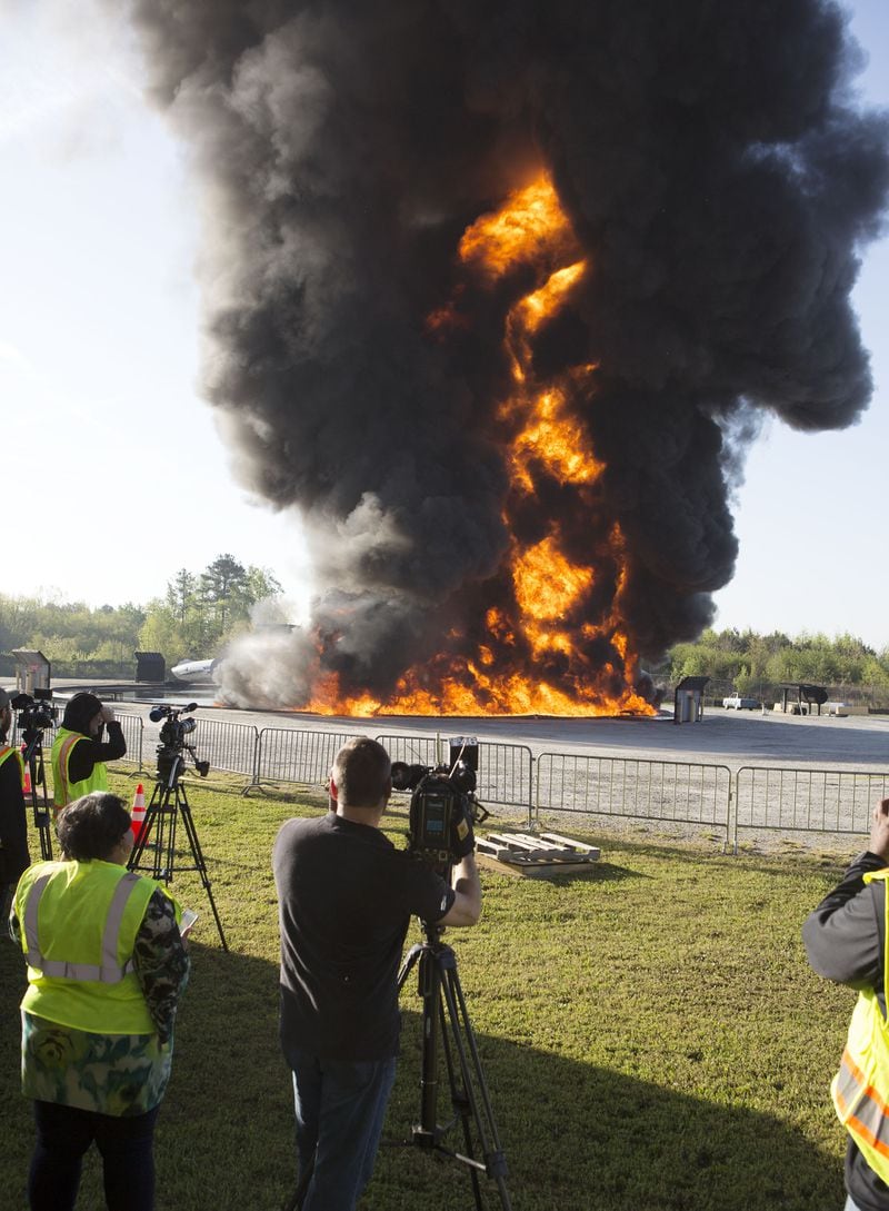 The media had to move back before of the intense heat of the flames as Hartsfield-Jackson International Airport held a full-scale disaster drill with Atlanta Firefighters, law enforcement, rescue personnel and nearly 150 volunteers who participated in a triennial exercise known as âBig Birdâ on Thursday, April 12, 2018. Airport personnel mobilized to a mock aircraft crash, extinguished the fire then triaged & treated the victims at a training site. The Federal Aviation Administration requires airports to conduct annual emergency preparedness drills and at least one full-scale drill every three years. (Photo by Phil Skinner)NOTE: getting Ids was impossible because the media was too far away.