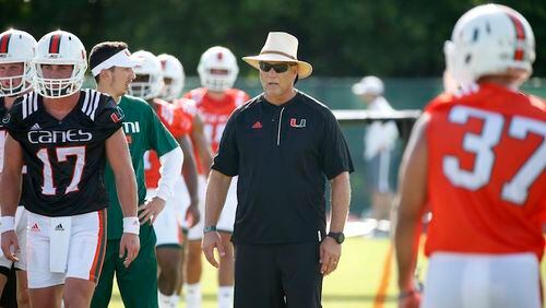 Miami head coach Mark Richt, center, looks on during practice on the first day of NCAA college football fall camp, Tuesday, Aug. 1, 2017 in Coral Gables, Fla. (AP Photo/Wilfredo Lee)