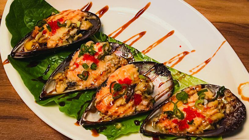 Baked green mussels at Mai Kitchen were a bit like oysters Rockefeller, only with Asian flavors. Henri Hollis/henri.hollis@ajc.com