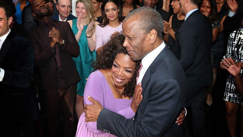 Oprah Winfrey hugs Sidney Poitier at her civil rights legends weekend last month. CREDIT: OWN
