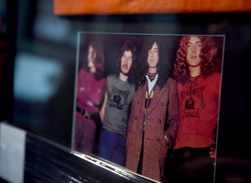 A framed photo of Led Zeppelin, including singer Robert Plant wearing a T-shirt from the Atlanta International Pop Festival. The memorabilia is part of a collection curated by Peter Conlon. Photo: RYON HORNE/RHORNE@AJC.COM