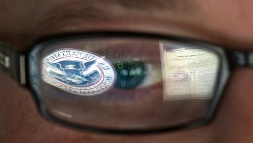 FILE - In this Sept. 30, 2011, file photo, a reflection of the Department of Homeland Security logo is seen reflected in the glasses of a cyber security analyst in the watch and warning center at the Department of Homeland Security's secretive cyber defense facility at Idaho National Laboratory in Idaho Falls, Idaho. Through history, the United States has relied on its borders and superior military might to protect against and deter foreign aggressors. But a lack of boundaries and any rulebook in cyberspace has increased the threat and leveled the playing field today. (AP Photo/Mark J. Terrill, File)