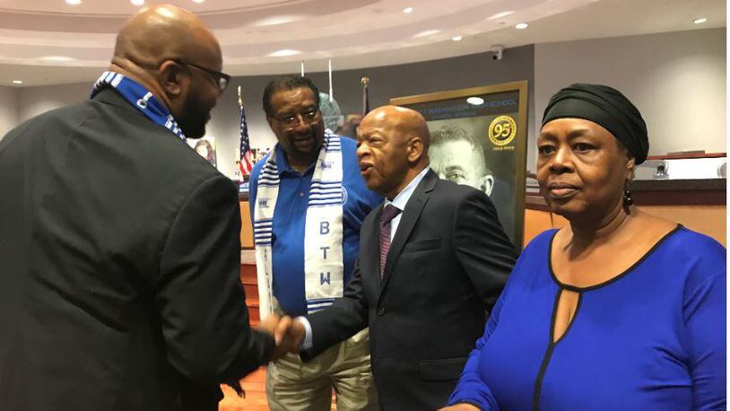 U.S. Rep. John Lewis, center, greets audience members in the Atlanta school board audience before the school board's Sept. 3, 2019, meeting. VANESSA McCRAY/AJC