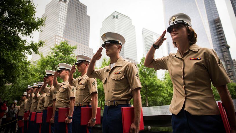 Members of the U.S. Marine Corps salute during a promotion ceremony at the National September 11 Memorial on May 23, 2014 in New York City. The ceremony took place in coordination with Fleet Week.
