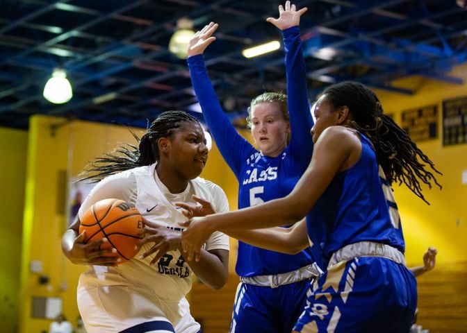 Adrieanna Browniee (left), center for South Dekalb High School, drives past Haley Johnson (middle), guard for Cass High School, and Londaisha Smith (right), wing for Cass High School on Friday, February 26, 2021, at South Dekalb High School in Decatur, Georgia. South Dekalb led Cass 42-17 at the half. CHRISTINA MATACOTTA FOR THE ATLANTA JOURNAL-CONSTITUTION