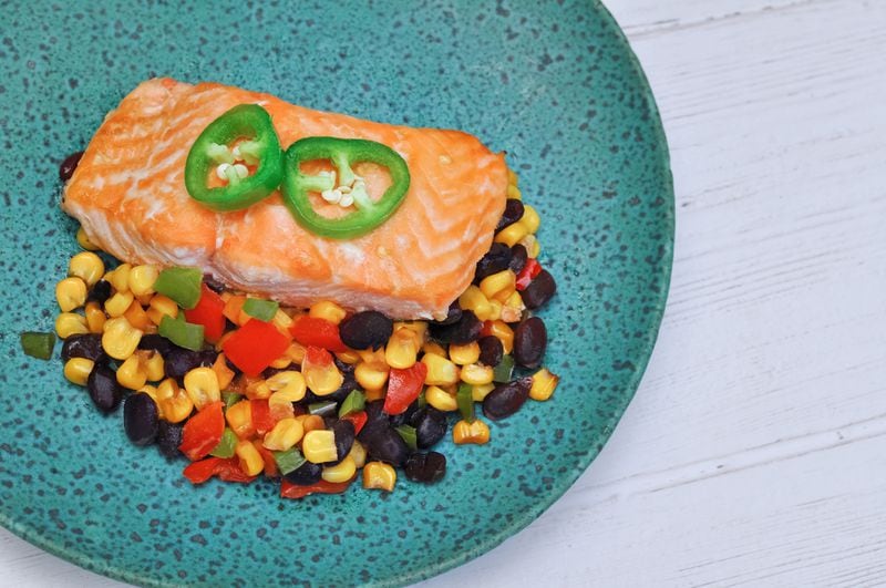 Kathleen's Catch offers take-and-bake single-serving fish and seafood dinners that change weekly. Pictured is honey jalapeno salmon, with black bean and corn salad over spinach. Courtesy of Kathleen's Catch