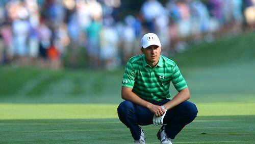 Jordan Spieth crouches near his ball on the first fairway during first round action of the PGA Championship at Quail Hollow Club Thursday in Charlotte. (Jeff Siner/Charlotte Observer)