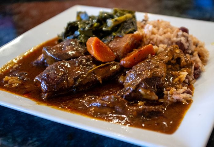 The brown stew chicken with rice and peas and collard greens at Rodney's Jamaican Soul Food. CONTRIBUTED BY HENRI HOLLIS