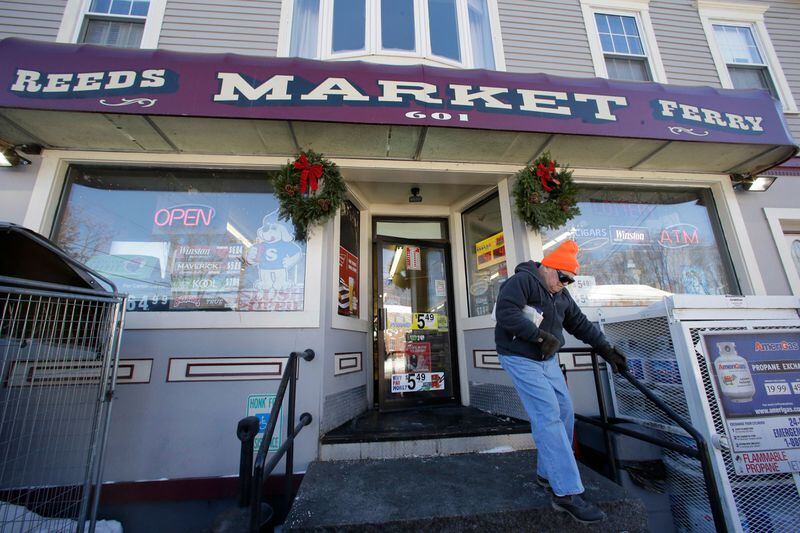 A customer departs Reeds Ferry Market convenience store, Sunday, Jan. 7, 2018, in Merrimack, N.H. AA Powerball ticket worth $560 million was sold at the store.