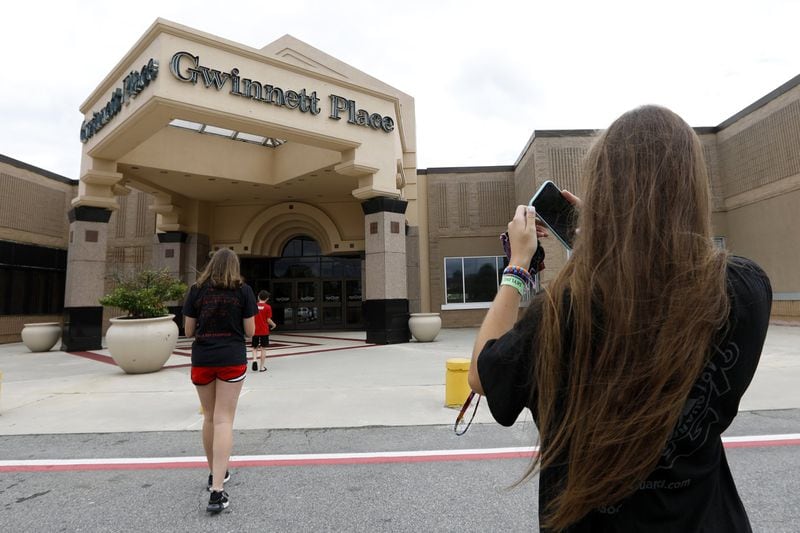 Brinley Rawson, a 17-year-old Stranger Things fan from Gwinnett County, snaps a photo of Gwinnett Place Mall. The Duluth mall has been losing shoppers and stores. That made room for Stranger Things to film much of season three at the mall, called Starcourt Mall in the show. (AP Photo/Andrea Smith)