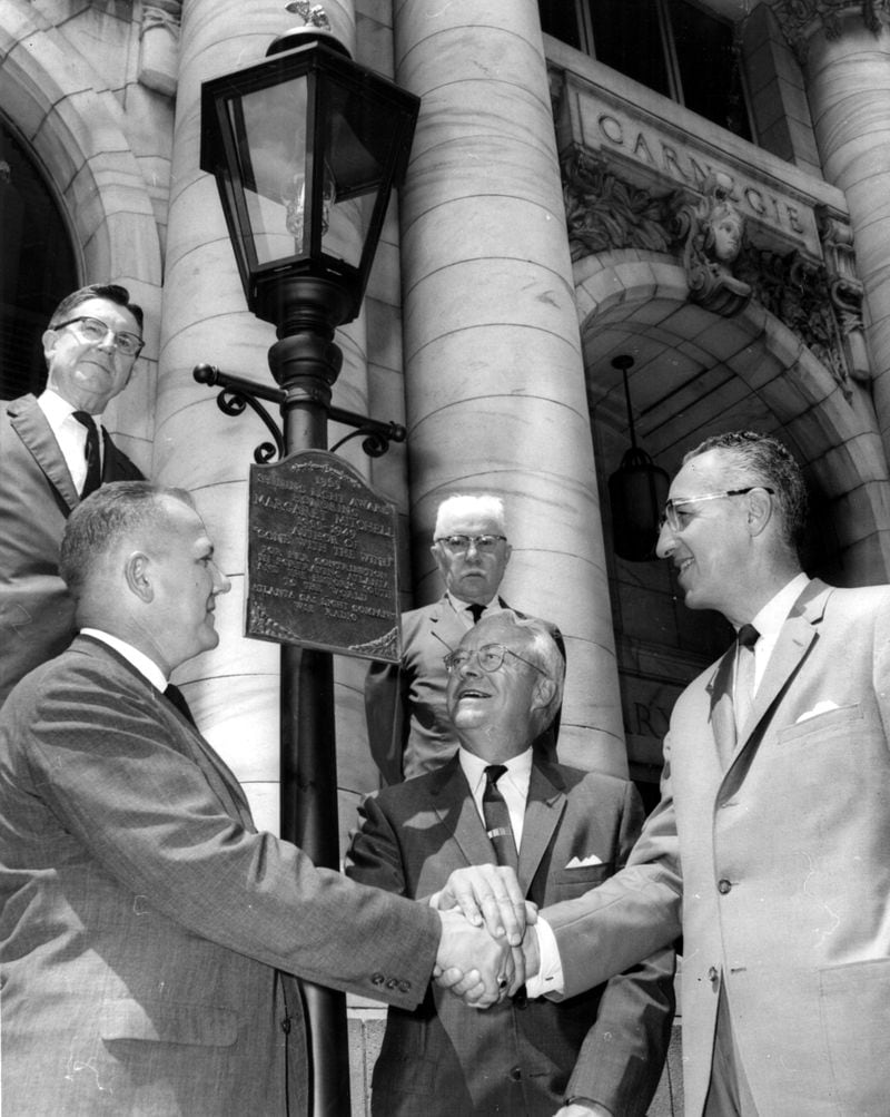 May 31, 1965 - Atlanta, Ga.: An eternal flame was installed Monday in front of the downtown Carnegie Library honoring Margaret Mitchell, author of 'Gone With the Wind.' Here at the Monday ceremony are, left to right, J.T. LaBoon, gas light company vice-resident; Mayor Ivan Allen Jr. and Elmo Ellis of WSB. (Staff photo/Ken Patterson)