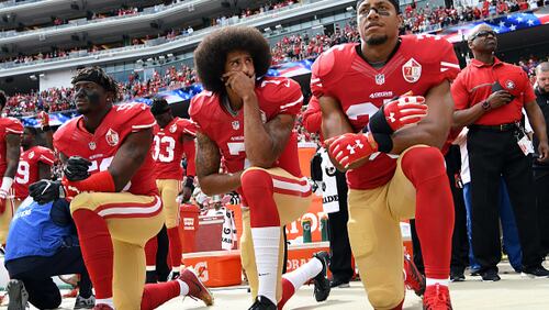 SANTA CLARA, CA - OCTOBER 02:   (L-R) Eli Harold #58, Colin Kaepernick #7 and Eric Reid #35 of the San Francisco 49ers kneel on the sideline during the anthem prior to the game against the Dallas Cowboys at Levi's Stadium on October 2, 2016 in Santa Clara, California. (Photo by Thearon W. Henderson/Getty Images)