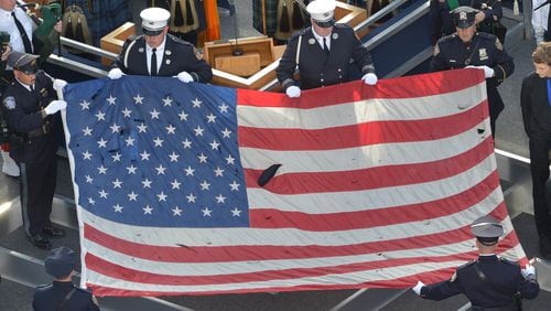 Pictured is a U.S. flag recovered from the 9/11 attacks is displayed by New York City Police officers and firefighters during the ceremony marking the 10th anniversary of the terrorist attack in 2011. In the September 11, 2001 attacks, Al-Qaeda hijackers crashed passenger planes into the World Trade Center in New York and the Pentagon in Washington, while a fourth jet crashed in Shanksville, Pennsylvania. (Mladen Antonov/AFP/Getty Images/TNS)
