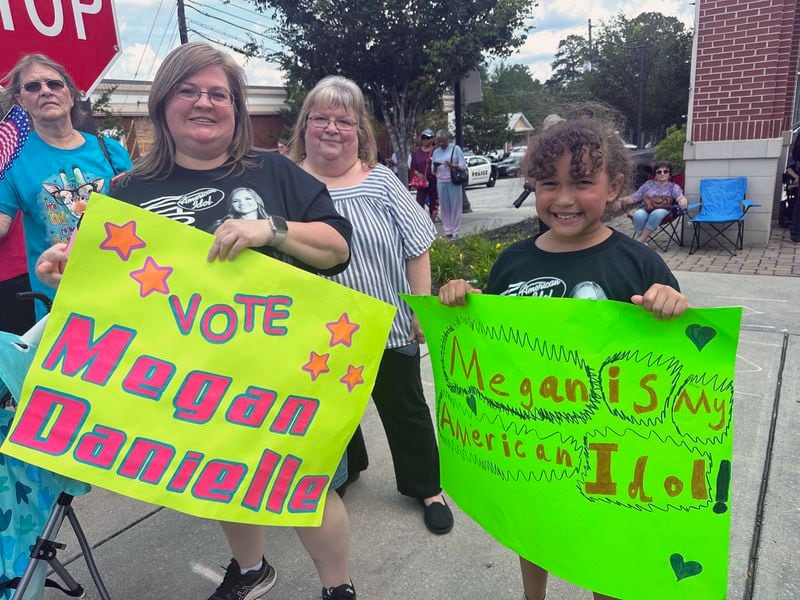 Rachel Dorough (left) came to the Douglasville parade to support Megan Danielle with her mom Miriam Smith and daughter Jaci. Dorough's daughter is married to Megan's brother. RODNEY HO/rho@ajc.com