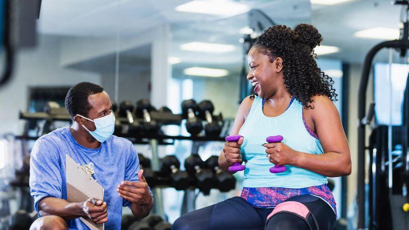 A coach offers fitness tips and support at the YMCA of Metro Atlanta. (FILE/Courtesy of the YMCA of Metro Atlanta)