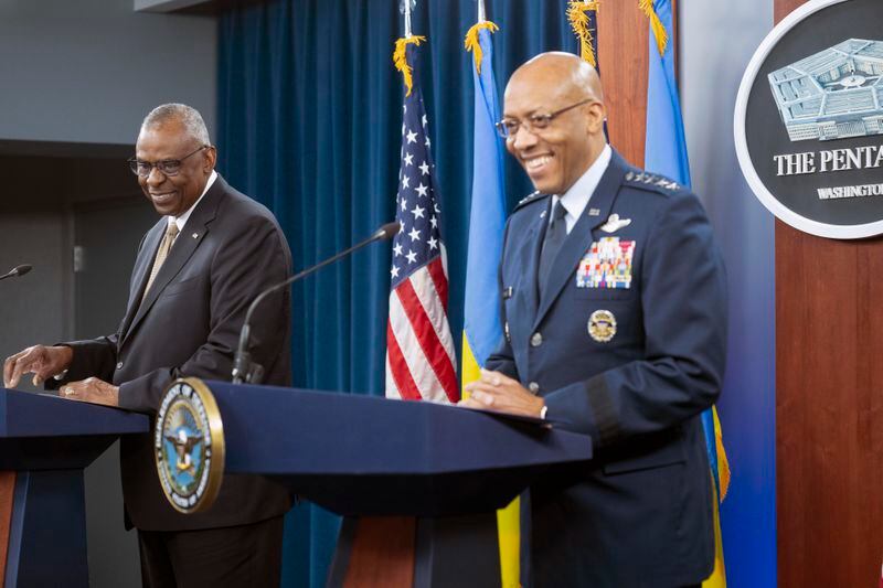Defense Secretary Lloyd Austin, left, and Chairman of the Joint Chiefs of Staff Gen. CQ Brown Jr., share a laugh at the start of a press briefing on Friday, April 26, 2024 at the Pentagon in Washington. (AP Photo/Kevin Wolf)