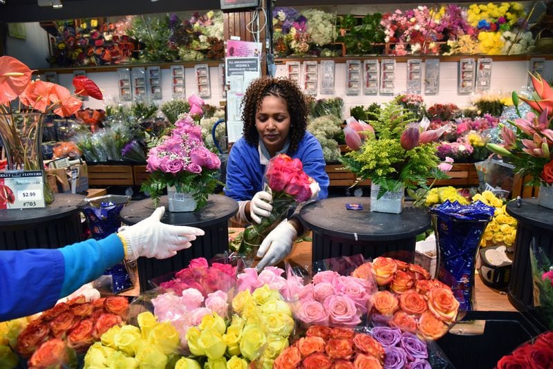 Hawilt Haile works in the floral section at DeKalb Farmers Market on Friday, February 24, 2017. 