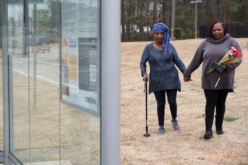 Exie Evans, left, and Marilyn Walton visit a MARTA bus stop in Clayton County on Friday, Feb. 9, 2024, where Timothy Crowley, Evans' nephew and Walton’s brother, was found dead. Crowley's family believes he was homeless at the time and they had been searching for him. (Ben Gray / Ben@BenGray.com)