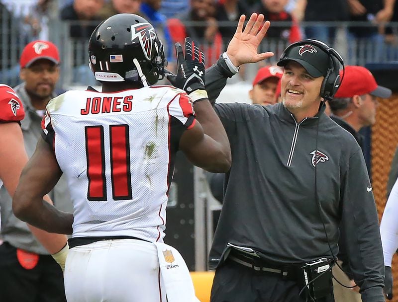 102515 NASHVILLE: -- Falcons wide receiver Julio Jones gets a high five from head coach Dan Quinn after scoring the game winning touchdown for a 10-7 victory over the Titans in a football game on Sunday, Oct. 25, 2015, in Nashville. Curtis Compton / ccompton@ajc.com