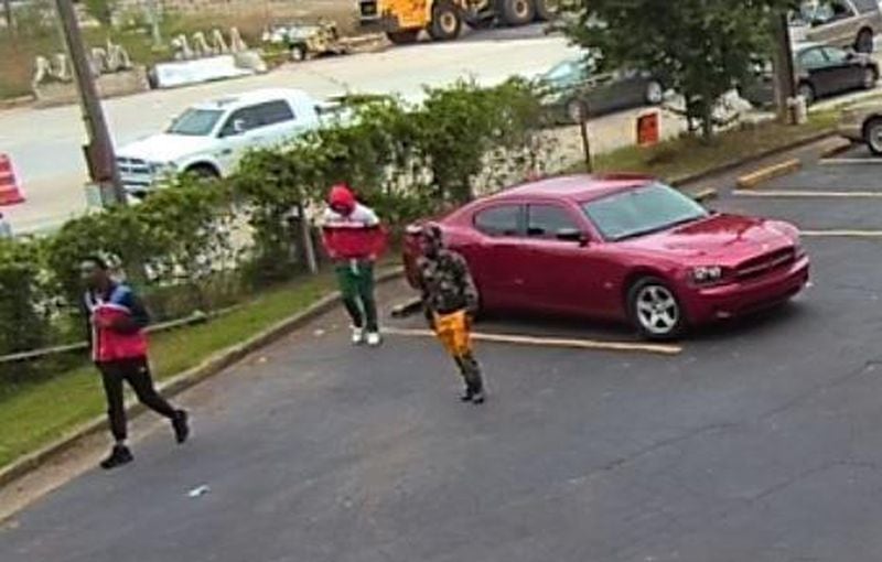 The man in the red-and-white hoodie is being sought by DeKalb County police. (Credit: DeKalb County Police Department)